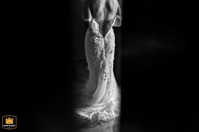 Tulum, Mexico, provides the location where the intricate wedding dress details are captured while spying through the curtains, showing the long train gracefully draping onto the floor.